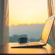laptop on desk during sunrise
